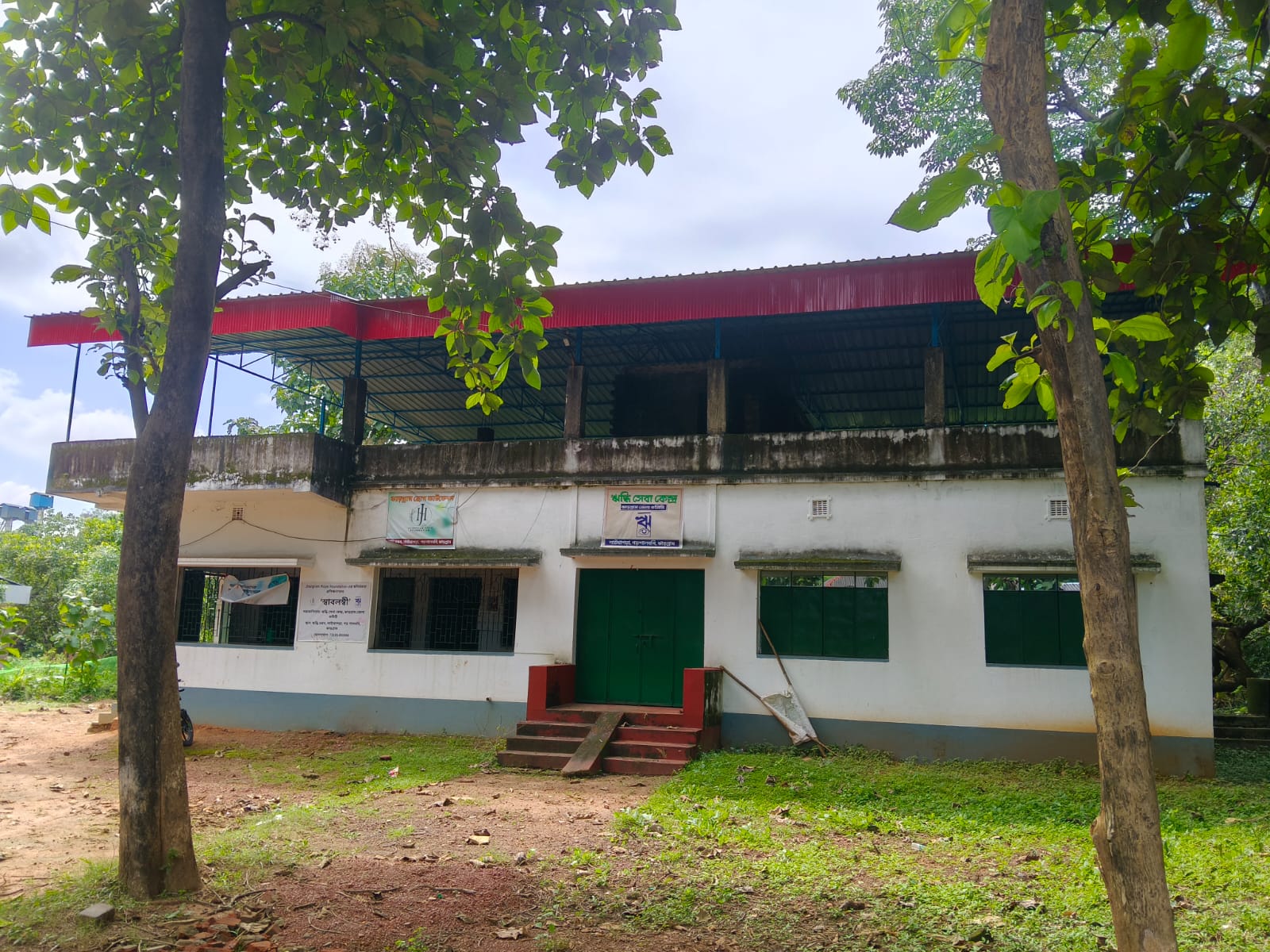 Riddhi Seva Kendra's community centre surrounded by trees in Jhargram